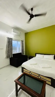 a bedroom with two beds and a ceiling fan at Mountain Breeze Neyyans in Attappādi