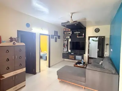 a living room with a couch and a television at Spacious 3BHK Mountain View -walk to palani temple in Palani