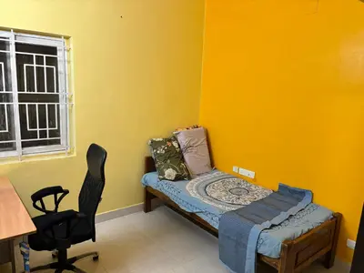 a room with a bed and a chair and a window at Spacious 3BHK Mountain View -walk to palani temple in Palani