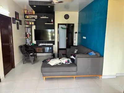 a living room with a couch and a table at Spacious 3BHK Mountain View -walk to palani temple in Palani
