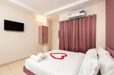 a hotel room with a bed with towels on it at Simqo By Nexa Hotels Group in Kozhikode