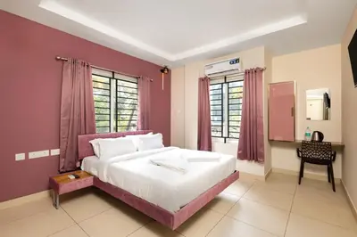 a bedroom with a large bed with purple walls at Simqo By Nexa Hotels Group in Kozhikode