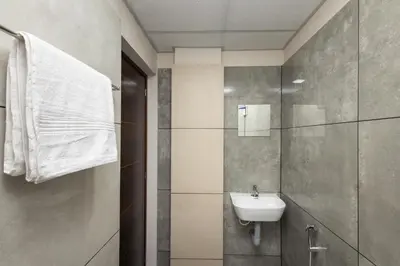 a bathroom with a sink and a mirror at Simqo By Nexa Hotels Group in Kozhikode