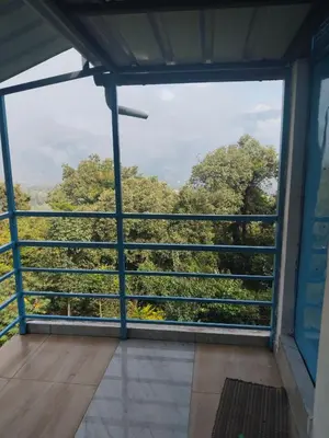 a view from the window of a room with trees at Nachiyar Hotel in Kanthalloor