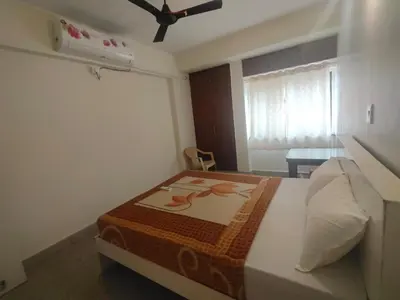 a bedroom with a bed in a room at Cabana 2bhk Elite in Mysore