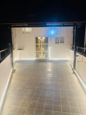 an empty room with a tiled floor with a blue light at Sihi Homes in Mysore
