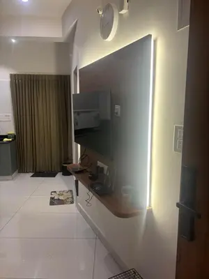 a room with a wall with a tv on a wall at Sihi Homes in Mysore