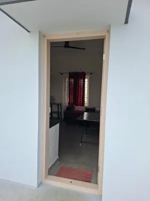 a view of a living room through a doorway at Belaku in Chāmundi