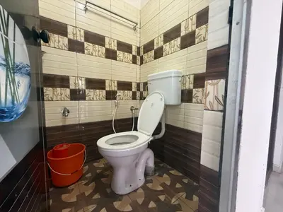 a bathroom with a toilet in a room at Cosy Kalpetta Villa in Kalpetta