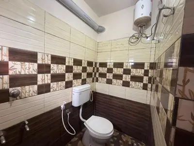a bathroom with a toilet and a shower at Cosy Kalpetta Villa in Kalpetta