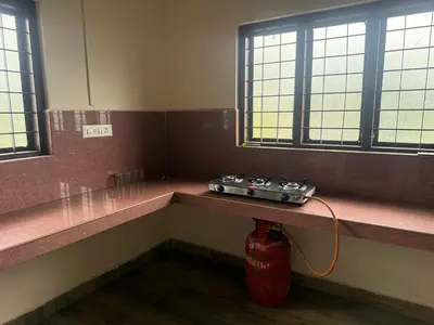 a fire extinguisher sitting on a counter in a room with windows at Cosy Kalpetta Villa in Kalpetta
