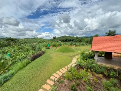 an overhead view of a garden with a red roof at Birdwing - Experiential Farmstay Resort by GoodEarth