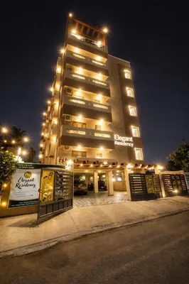 a tall building with lights on top of it at Elegant Residency in Coimbatore