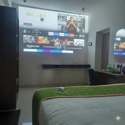 a bedroom with a large tv on the wall at Elegant Residency in Coimbatore