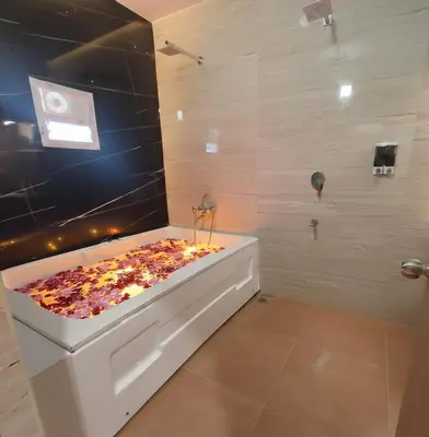 a bathroom with a bath tub with flowers in it at Elegant Residency in Coimbatore