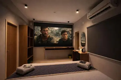 a bedroom with a large screen tv in a room at Elegant Residency in Coimbatore