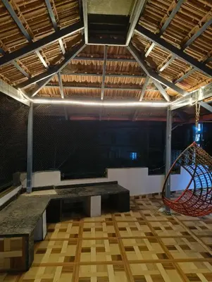 an empty room with a stage and a slide at Coorg Refresh Homestay in Kushālnagar