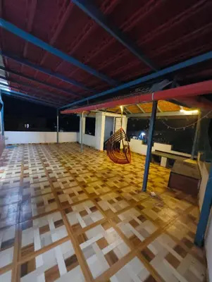 an empty room with a wooden floor and a ceiling at Coorg Refresh Homestay in Kushālnagar