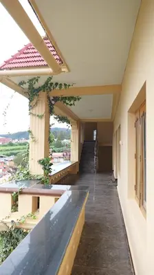 a corridor of a building with a balcony at Happy Villa By Eden Luxury Stay in Ooty