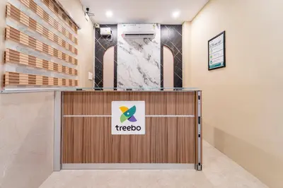 a tico sign on a reception desk in a lobby at Treebo Dunag in Coimbatore