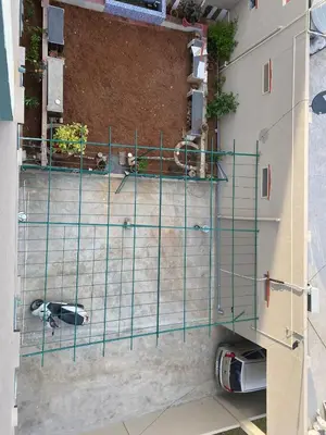 a dog in a cage in a building at Abhi home stay in Mysore
