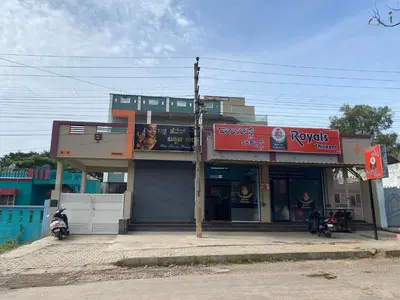 a building with a motorcycle parked in front of it at Abhi home stay in Mysore