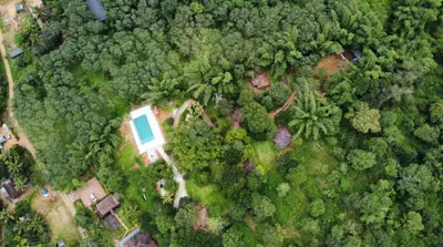 an overhead view of a house in the forest at Misty Night Wayanad Pool Resort in Wayanad