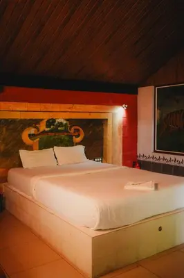 a bedroom with a large white bed in a room at Misty Night Wayanad Pool Resort in Wayanad