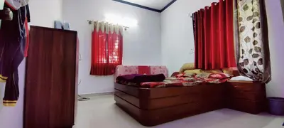 a living room with a couch and red curtains at Nature stay GF in Hārohalli