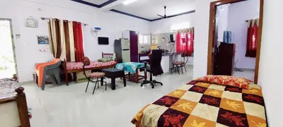 a room with a bed and a table and chairs at Nature stay GF in Hārohalli