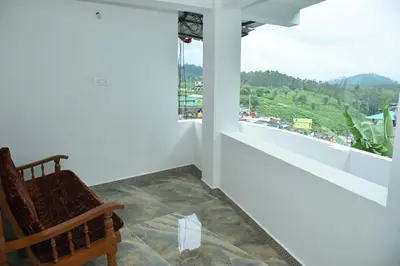 a chair sitting in a room with a window at Murugan Homestays in Vālpārai