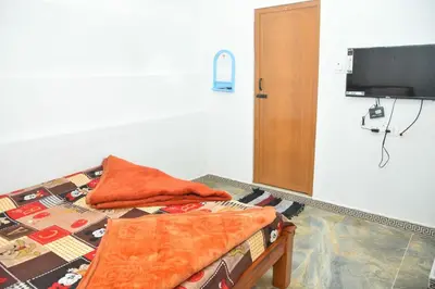 a bed with two pillows on it in a room at Murugan Homestays in Vālpārai
