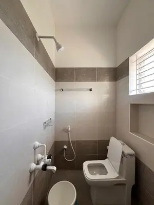 a small bathroom with a toilet and a shower at The coconest Kinathukadavu, Coimbatore in Kinattukkadavu