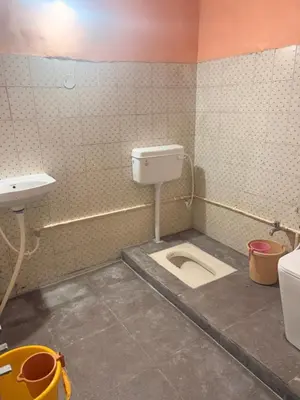 a bathroom with a toilet and a sink at The Green residence in Mysore