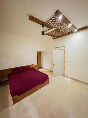 a bedroom with a large bed in a room at Akshaya Homestay in Trichūr