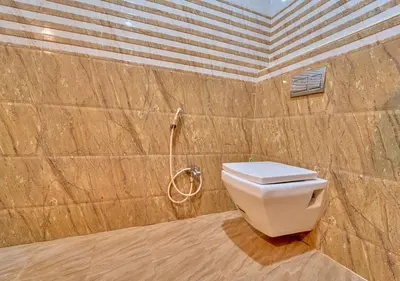 a bathroom with a toilet and a shower at Pine Forest View Ooty by VOYE HOMES in Ooty