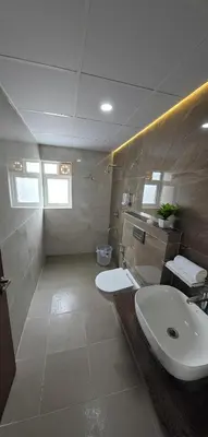 a bathroom with a sink and a toilet at Broadway Inn in Mysore