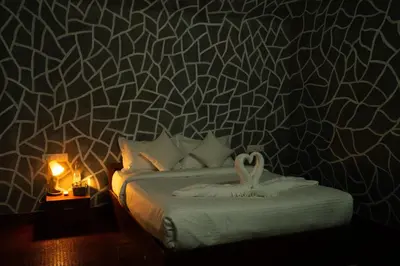 a bedroom with a bed with a swan on the wall at Villa La Vista Homestay in Calicut