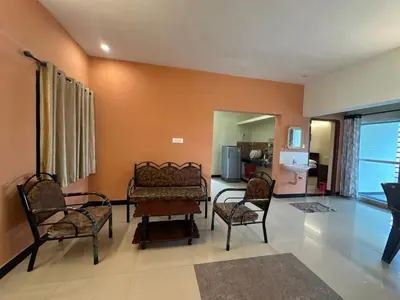 a living room with a couch and two chairs at SPICE HOMESTAY Apartment in Singānallūr