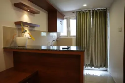 a kitchen with a counter and a sink and a window at Pearl Residency Kalady in Kāladi