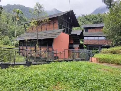 a house in the middle of a grassy hill at Moonrise Valley Freshwave Resorts Pvt Ltd in Koroth