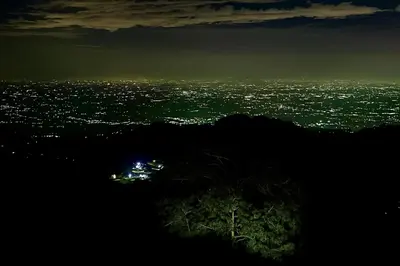 a view of a city lit up at night at Humming Bird By Brown Tree Resorts in Kotagiri