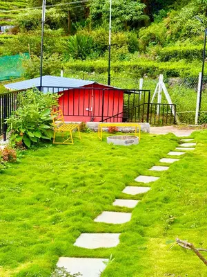 a garden with a bench and a table and a playground at Humming Bird By Brown Tree Resorts in Kotagiri