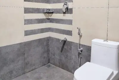 a bathroom with a shower with a toilet in it at Malayil Peacock Villa in Wayanad