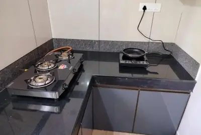 a kitchen with a stove and a pan on a counter at Malayil Peacock Villa in Wayanad
