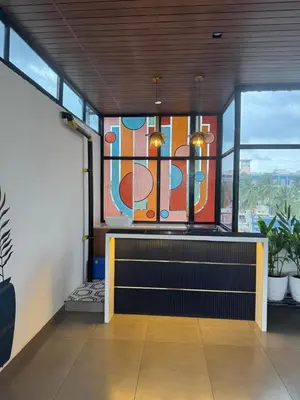 a room with a bench and a stained glass window at Event House, Mysore in Mysore