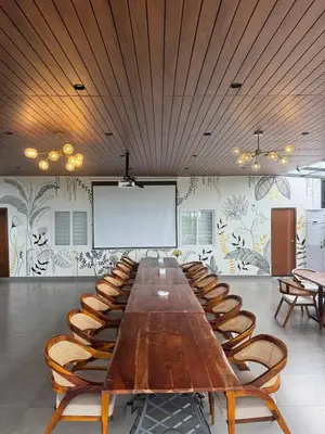 a large conference room with a long table and chairs at Event House, Mysore in Mysore