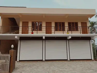 a house with four garage doors in front of it at Anna rooms in Chekadi