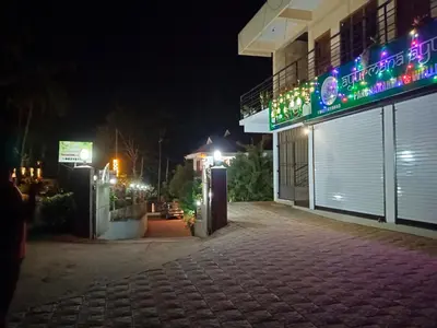 an empty street at night with a building at Anna rooms in Chekadi