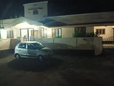 a small car parked in front of a house at night at Shield Guest Accommodation in Pudunagaram